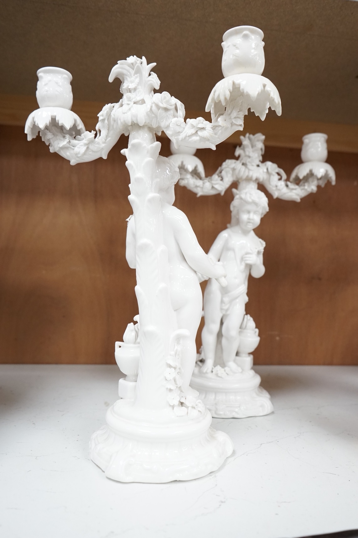 A pair of figural two branch candelabra, crossed swords marks, 36cm high